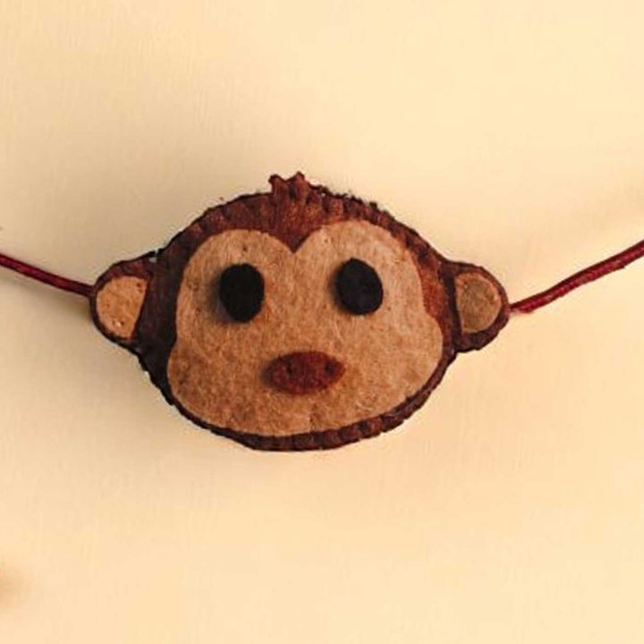 Handmade Beaded Monkey Theme Pom Pom Felt Rakhi With Roli Chawal For Kids - Front Close-up View