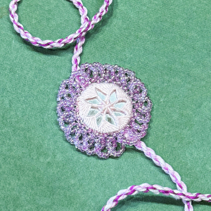 Handmade Reusable Lavender Mirror And Jhumki Rakhi For Brother - Close-up of Embroidered Detail