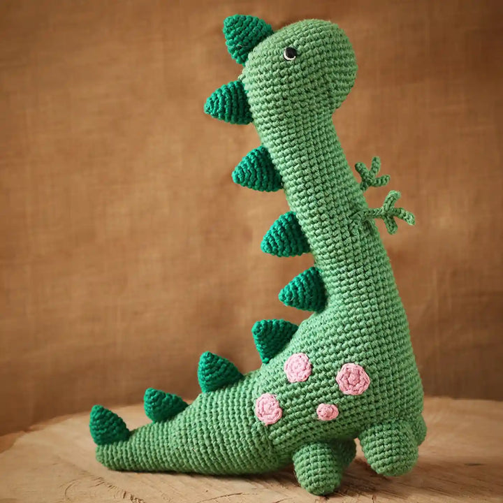 Handmade Crochet Dino Theme Kids Rakhi And Toy Combo With Roli Chawal Set Of 2 - Side View of Crochet Dinosaur Toy
