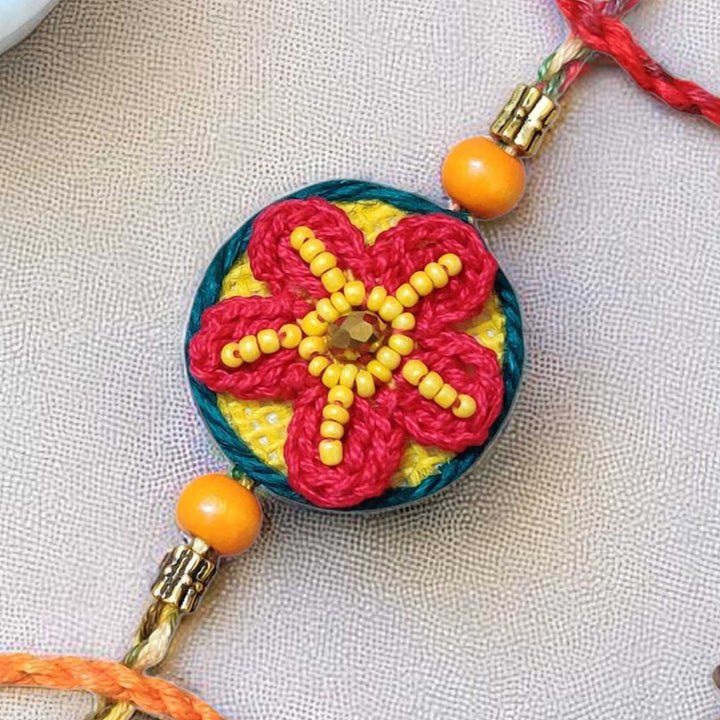 Handmade Crochet Flower Theme Cotton Rakhi With Roli Chawal - Close-up of decorative centerpiece