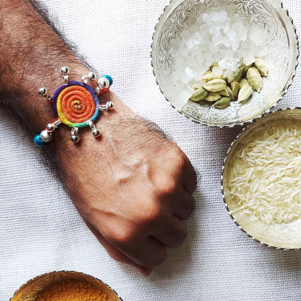 Handmade Dori Work Round Multicolor Gunghroo Rakhi With Roli Chawal - Worn on Wrist Display