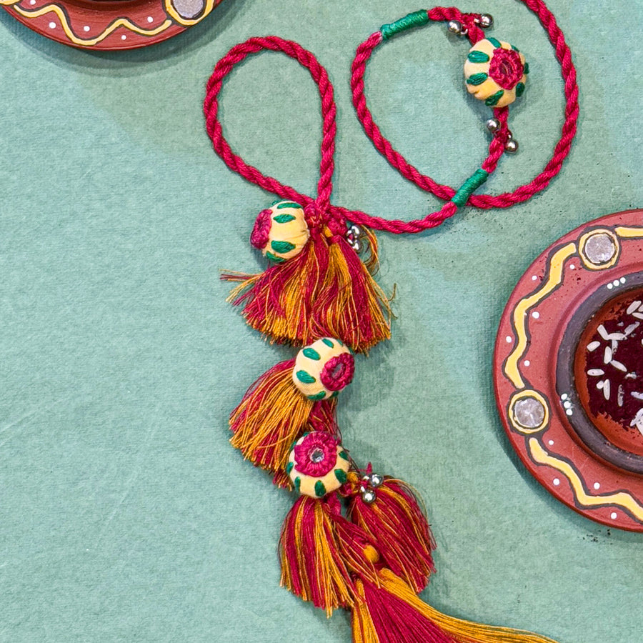 Handmade Reusable Red Potli And Jhumki Rakhi For Bhabhi - Close-up of Tassel Detail