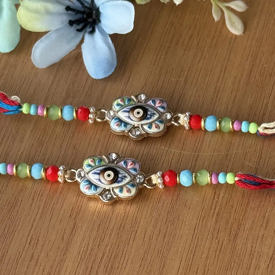 Handmade Multicolor Beaded Evil Eye Rakhi With Roli Chawal - Close-up of two bracelets