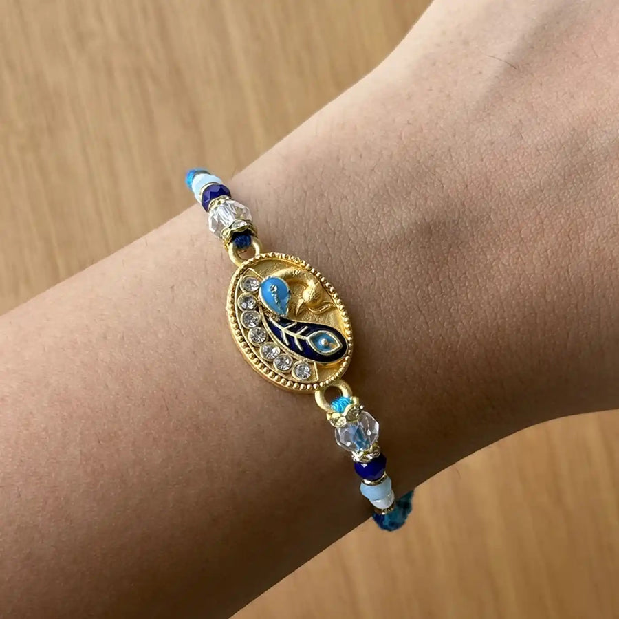 Handmade Beaded Peacock Rakhi With Roli Chawal - Wrist Display View