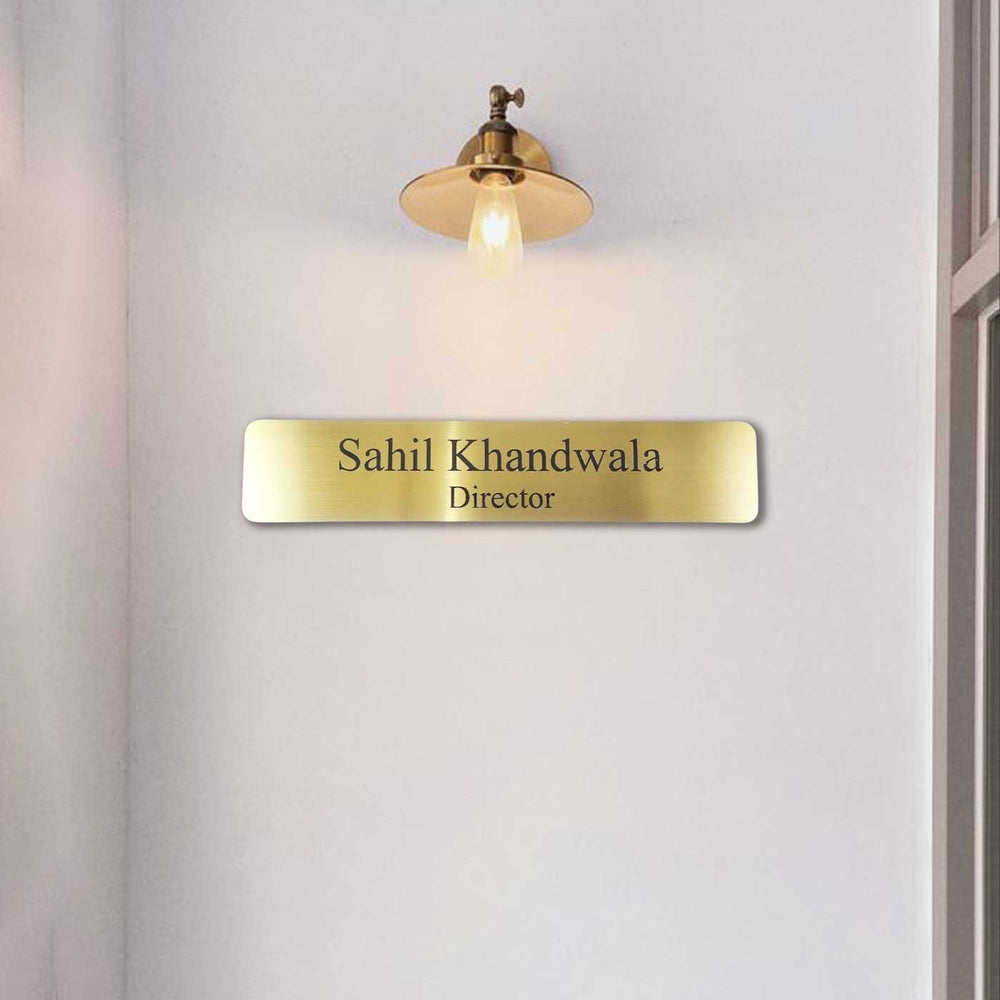 Personalized Weatherproof Sleek Gold Stainless Steel Name Plate - Mounted on Wall Below Light Fixture