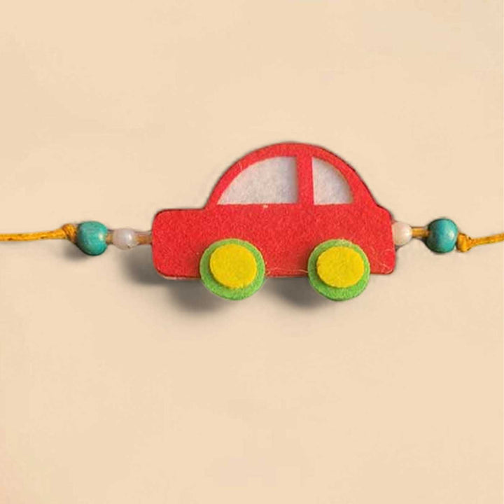 Customized Handmade Beaded Car Theme Pom Pom Felt Rakhi With Roli Chawal For Kids - Red Car Bracelet Close-up