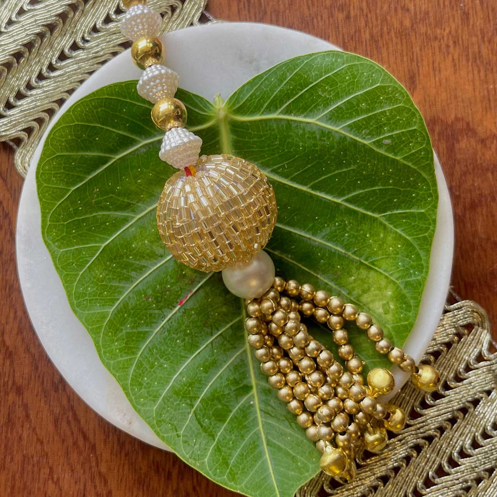 Handmade Blue And Gold Design Pearl And Stone Bhaiya Bhabhi Rakhi - Close-up of Tassel Detail