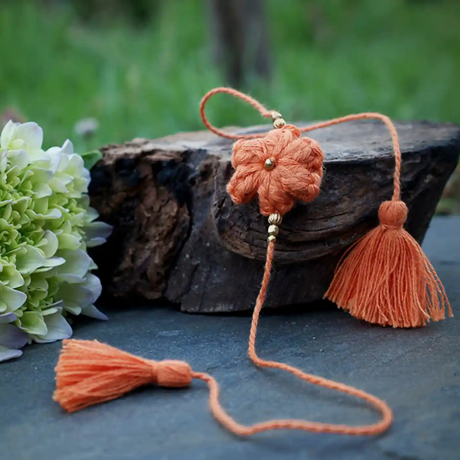 Handmade Crochet Blue Flower Rakhi With Roli Chawal - Orange Threaded Flower Close-up