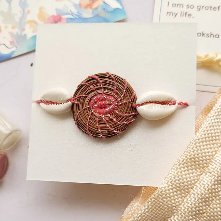 Eco Friendly Handmade Sea Shell Pine Needle Rakhi With Pouch And Roli Chawal - Close-up Front View on Card