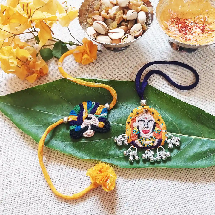 Handmade Dori Work And Ghungroo Raja Rani Bhaiya Bhabhi Rakhi With Roli Chawal Set Of 2 - Flat Lay with Decorative Items