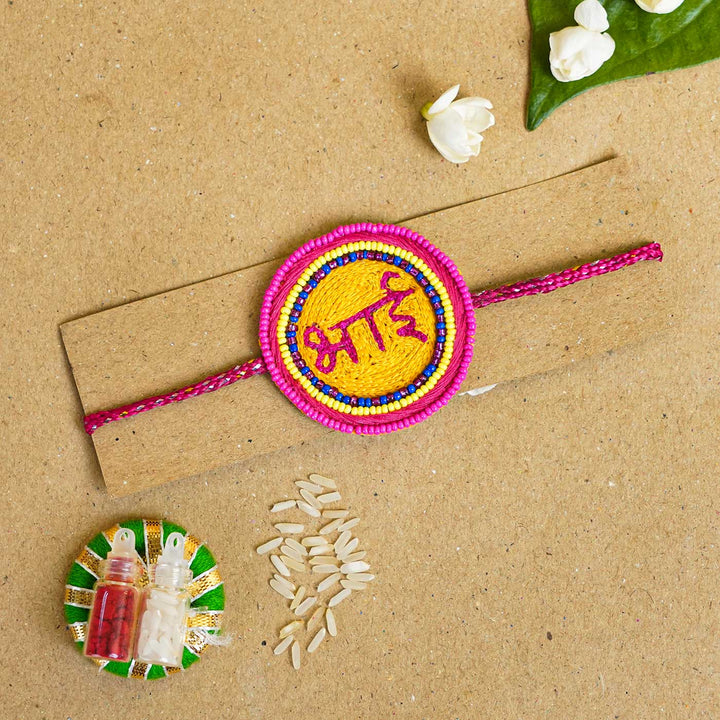 Handmade Beaded Bhai Rakhi With Roli Chawal - Flat Lay with traditional items
