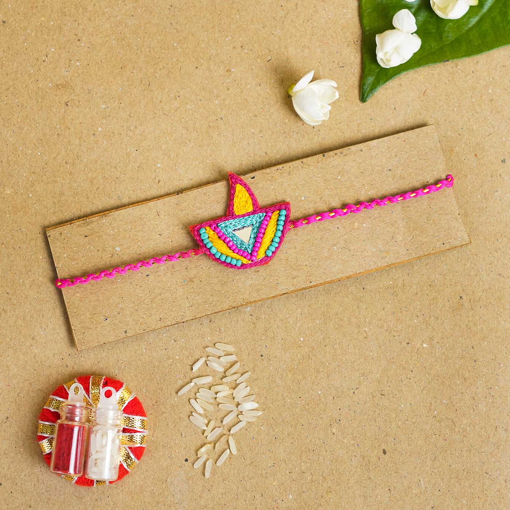 Handmade Beaded Diya Rakhi With Roli Chawal - Flat Lay on Display Card