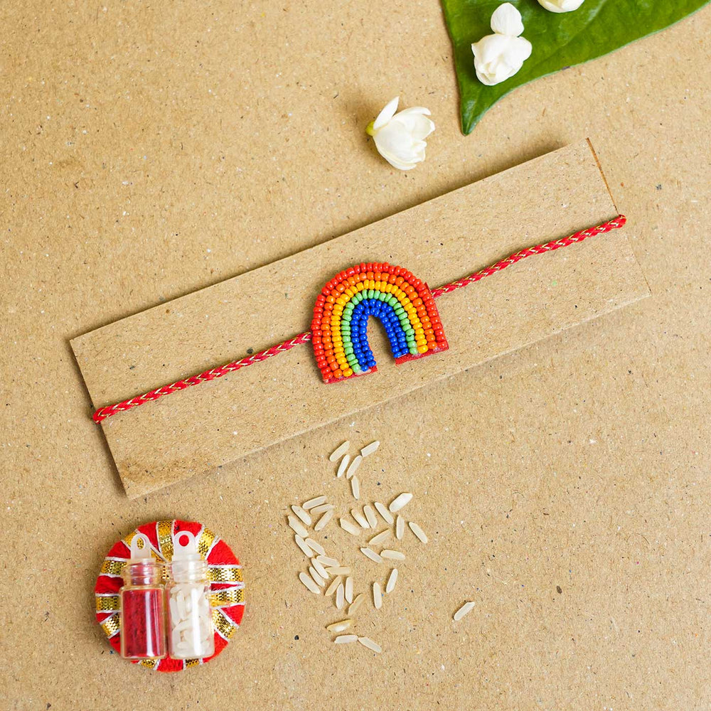 Handmade Beaded Rainbow Rakhi With Roli Chawal - Flat Lay with Raksha Bandhan Items