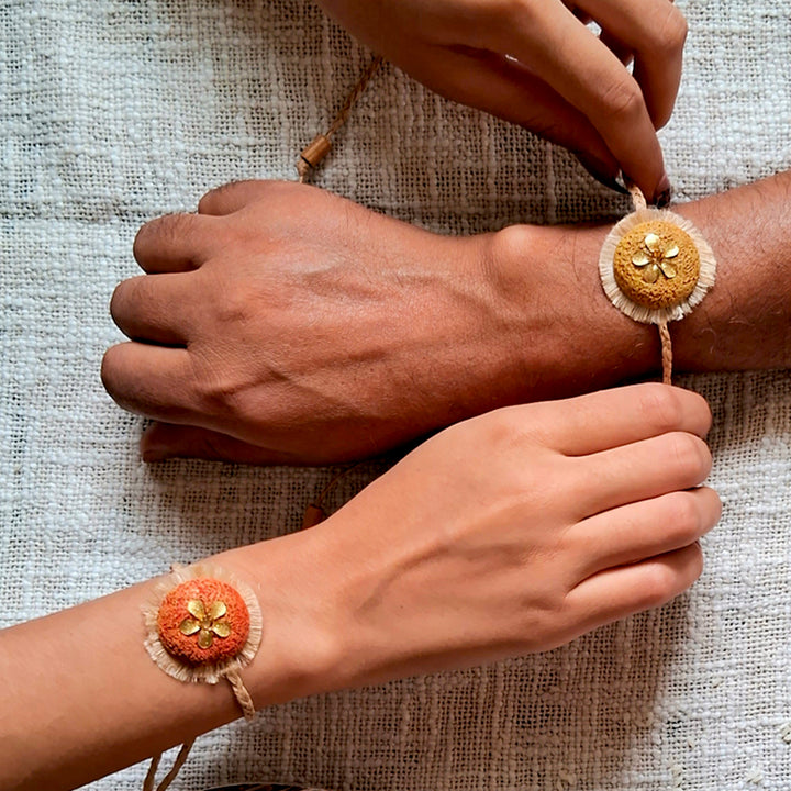 Handmade Papier Mache Rustic Floral Rakhi With Roli Chawal - Matching Rakhi worn on wrists