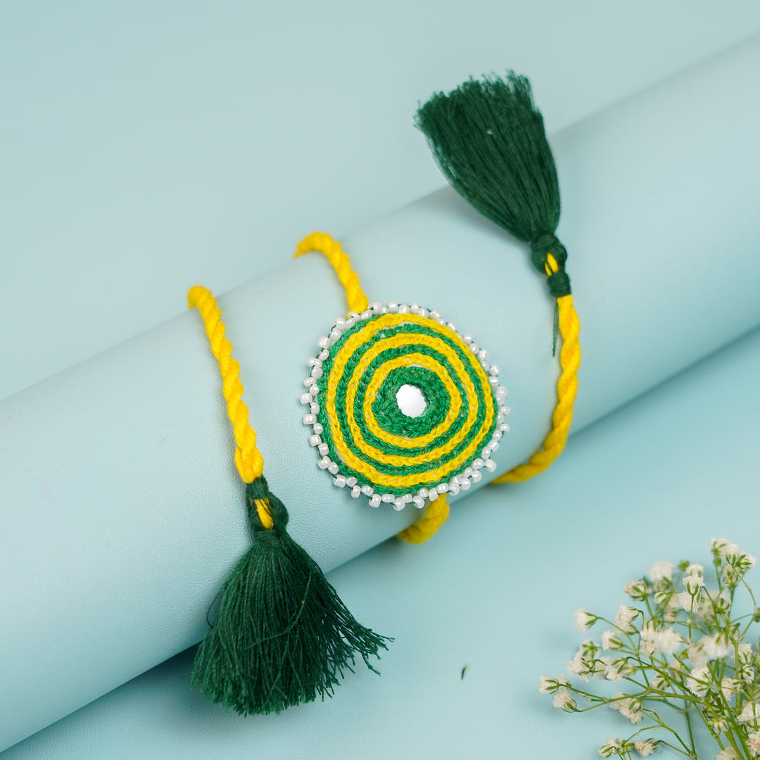 Handmade Reusable Yellow And Green Mirror And Jhumki Cotton Rope Rakhi For Brother - Close-up on Bracelet Detail