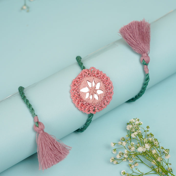 Handmade Reusable Pink And Green Mirror Jhumki Rakhi For Brother - Wrapped Around Cylindrical Display Stand