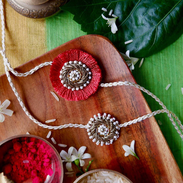 Handmade Zardozi Mustard And White Bead Work Rakhi With Wooden Box And Roli Chawal Set Of 2 - Flat Lay Display on Wooden Tray