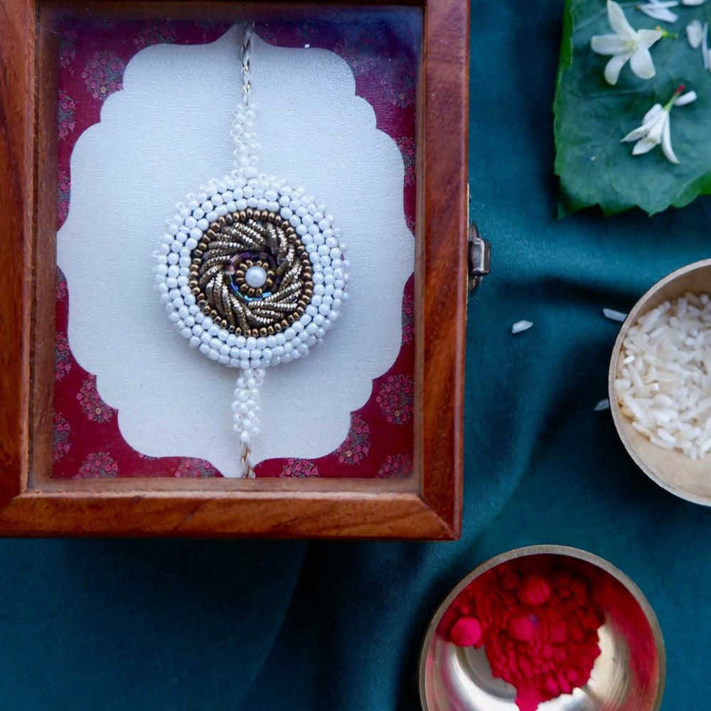 Handmade Zardozi White Bead Border Rakhi With Wooden Box And Roli Chawal - Packaged in Wooden Box
