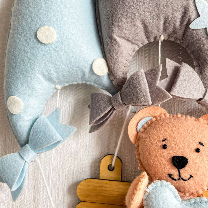 Personalized Blue Teddy On A Swing Theme Felt Kids Name Plate - Close-up of Hanging Nursery Mobiles