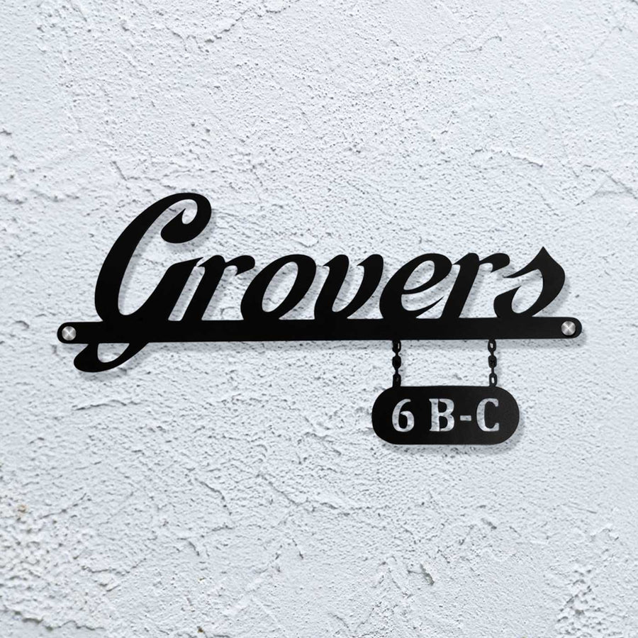 Personalized Waterproof Sleek Black Metal Name Plate - Mounted on White Textured Wall