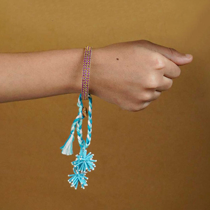Reusable Beaded Blue Flower Lumba Rakhi For Bhabhi With Roli Chawal - On wrist lifestyle display