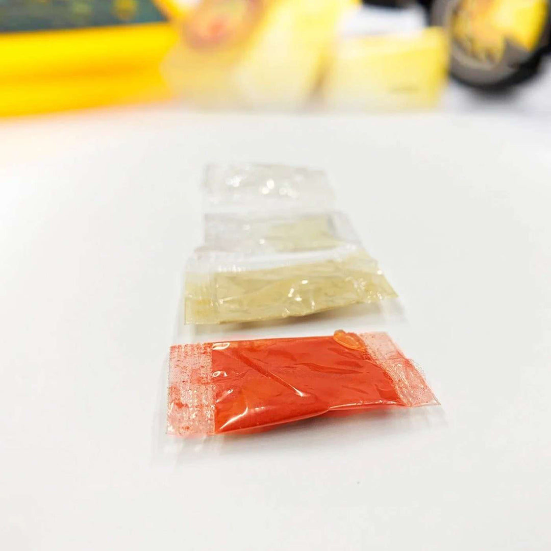 Handmade Rondu Bhai Wooden Rakhi With Roli Chawal - Close-up of spice packets in packaging