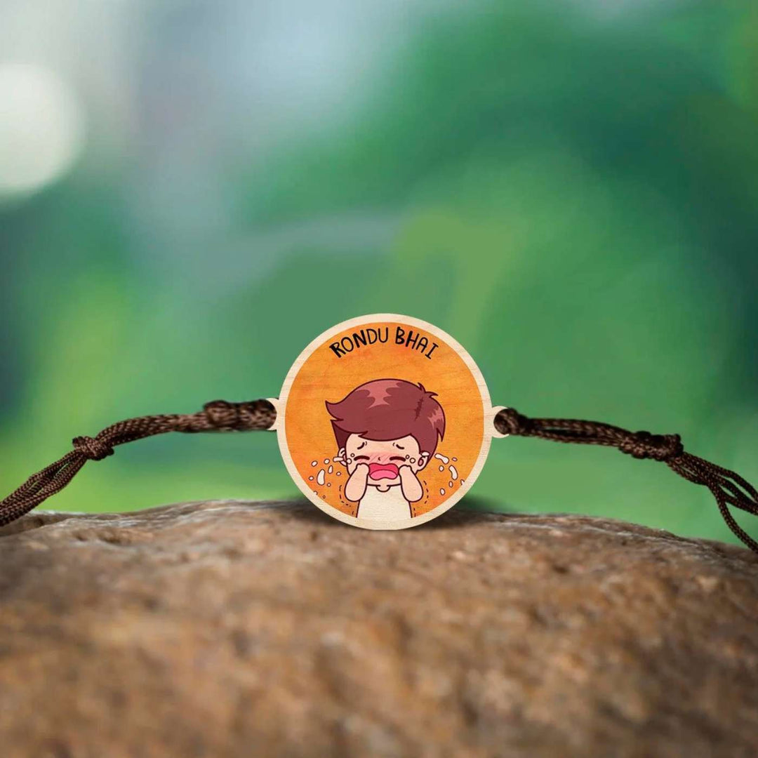 Handmade Rondu Bhai Wooden Rakhi With Roli Chawal - Rakhi displayed on natural background