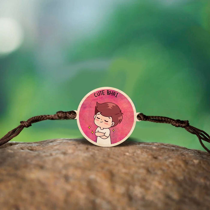 Handmade Cute Bhai Wooden Rakhi With Roli Chawal - Rakhi displayed on natural surface