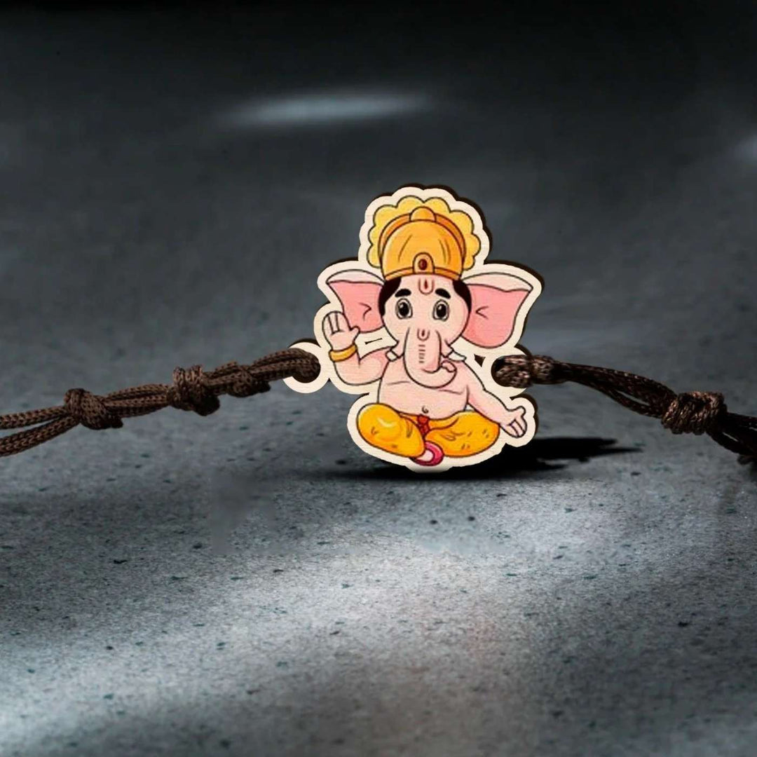 Handmade Ganesha Wooden Rakhi With Roli Chawal - On Textured Surface Display