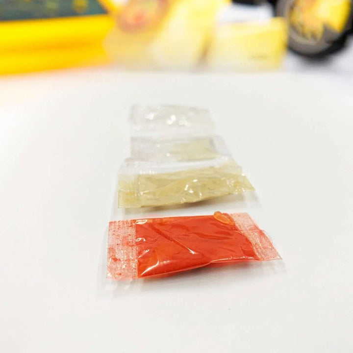 Handmade Kumbhkaran Bhai Wooden Rakhi With Roli Chawal - Food Ingredient Packets Close-up