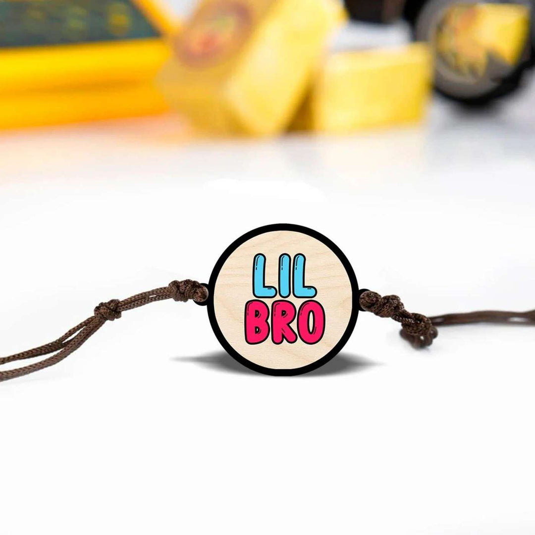Handmade Little Bro Wooden Rakhi With Roli Chawal - Bracelet front view with blurred background
