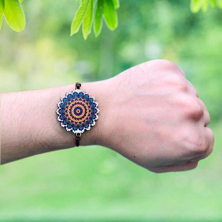 Handmade Mandala Wooden Rakhi With Roli Chawal - Wearing on Wrist