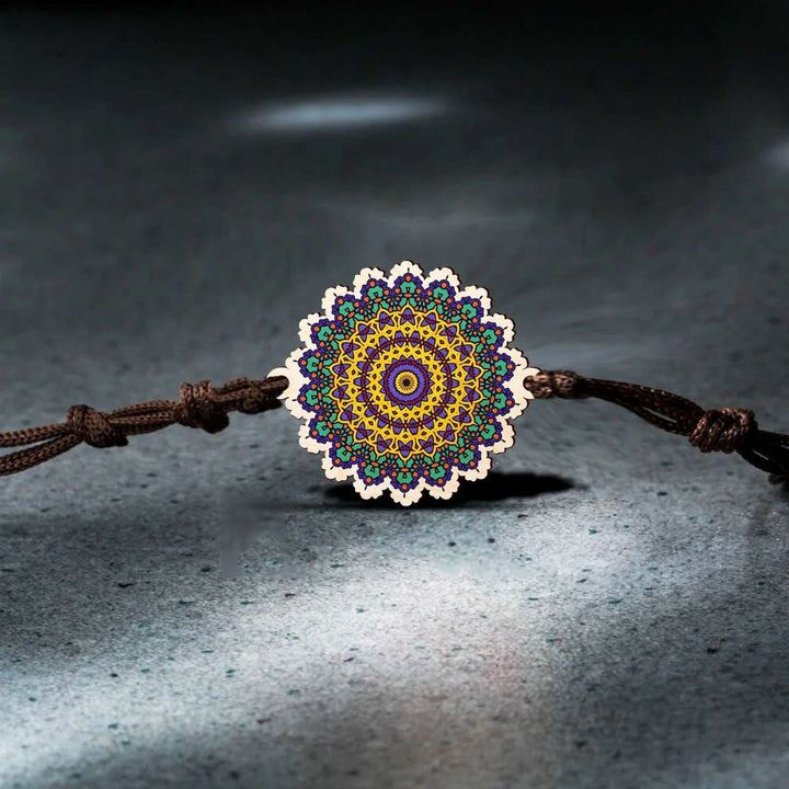 Handmade Mandala Wooden Rakhi With Roli Chawal - Front View on Dark Background