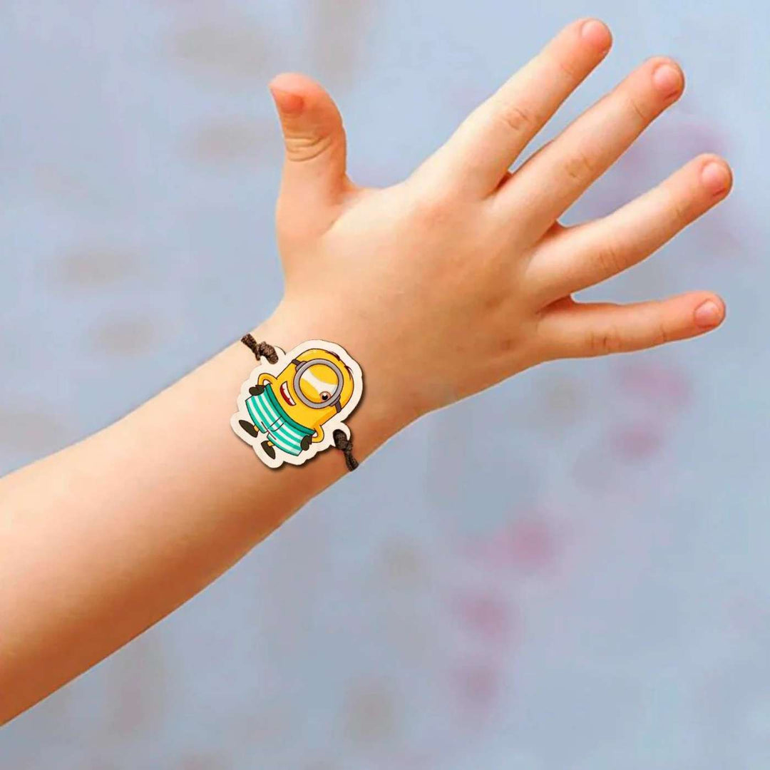 Handmade Minion Wooden Kids Rakhi With Roli Chawal - On Wrist Display