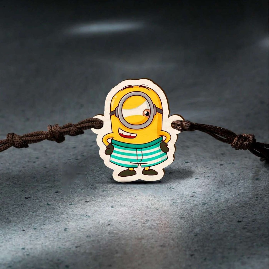 Handmade Minion Wooden Kids Rakhi With Roli Chawal - Close-up in Dark Background