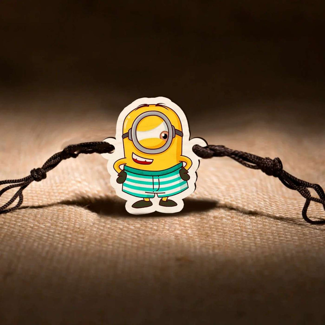 Handmade Minion Wooden Kids Rakhi With Roli Chawal - Close-up in Textured Background