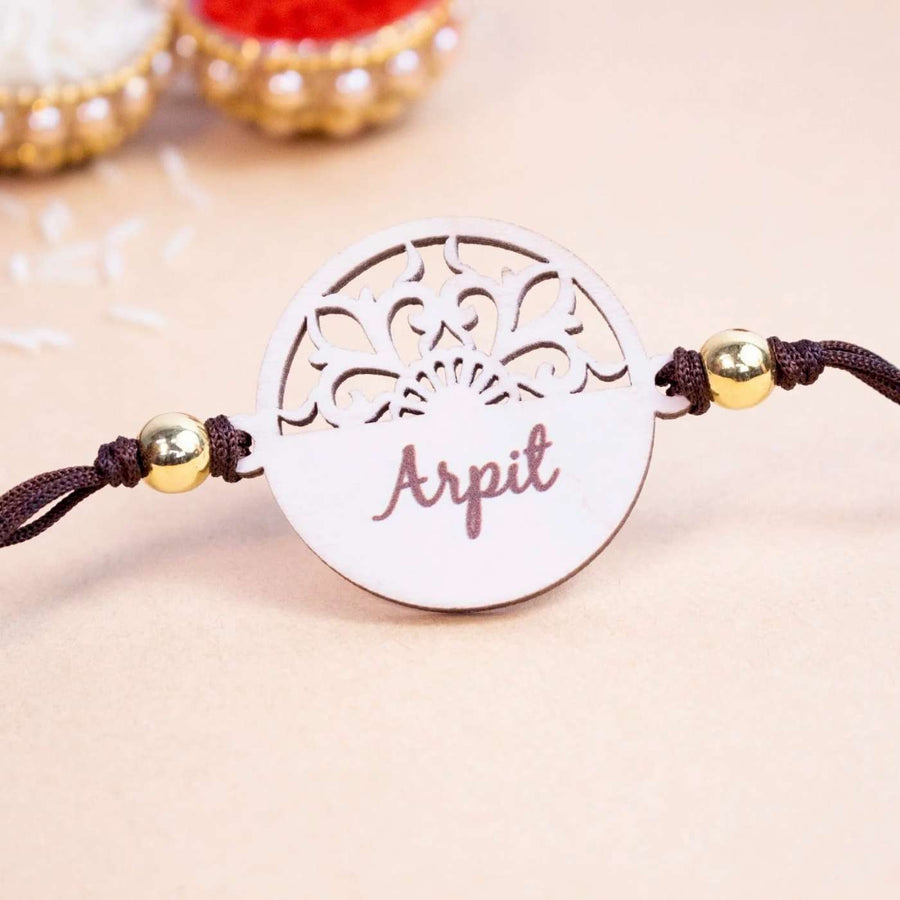 Personalized Handmade Elegant Wooden Rakhi With Roli Chawal - Close-up of Name Engraving