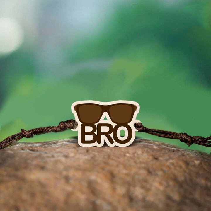 Handmade Sunglasses Bro Wooden Rakhi With Roli Chawal - Bracelet on natural rock surface