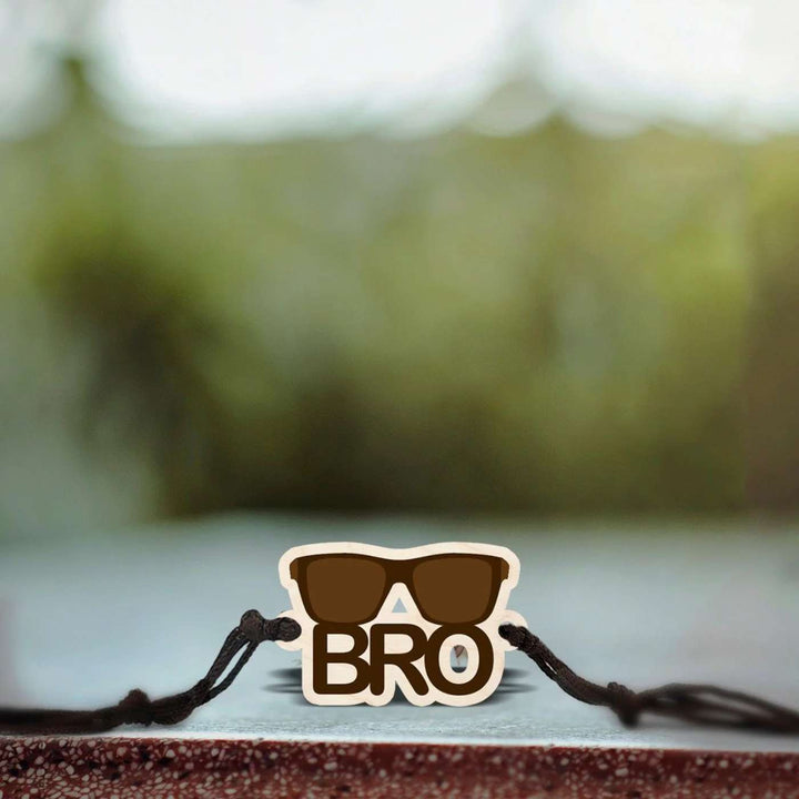 Handmade Sunglasses Bro Wooden Rakhi With Roli Chawal - Bracelet on outdoor stone surface