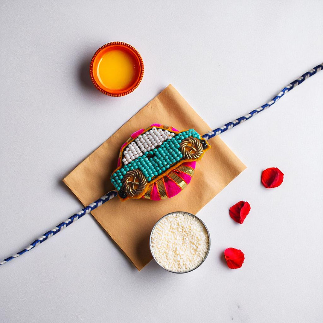 Handmade Reusable Pink Car Felt Kids Rakhi - Styled Flat Lay with Accessories