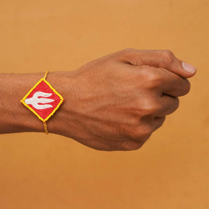 Handmade Beaded Trishul Rakhi With Roli Chawal - Rakhi worn on wrist, side view