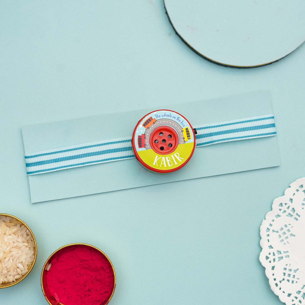 Personalized Musical Wheels On The Bus Kids Rakhi With Roli Chawal - Front View Display on Card