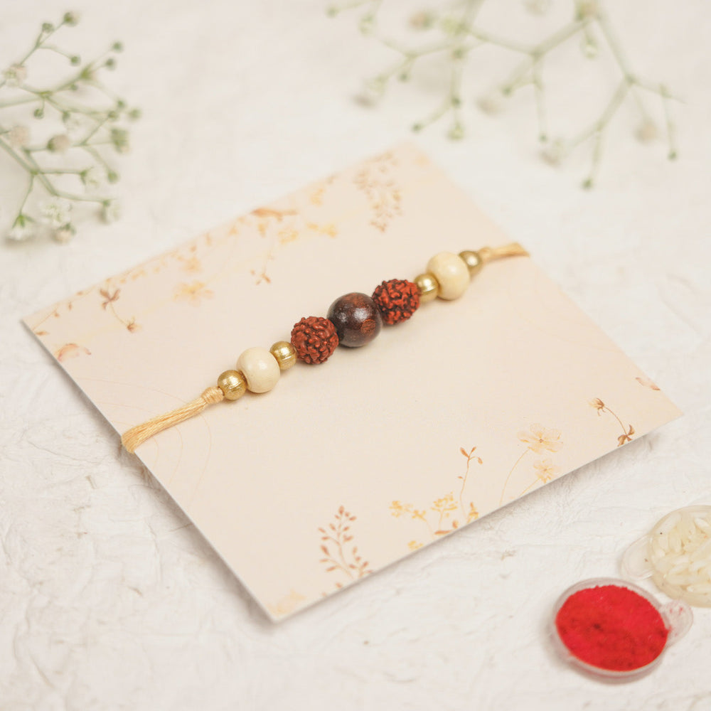 Handmade Pearl Lehar Rudraksha Rakhi With Roli Chawal - Angled View on Display Card
