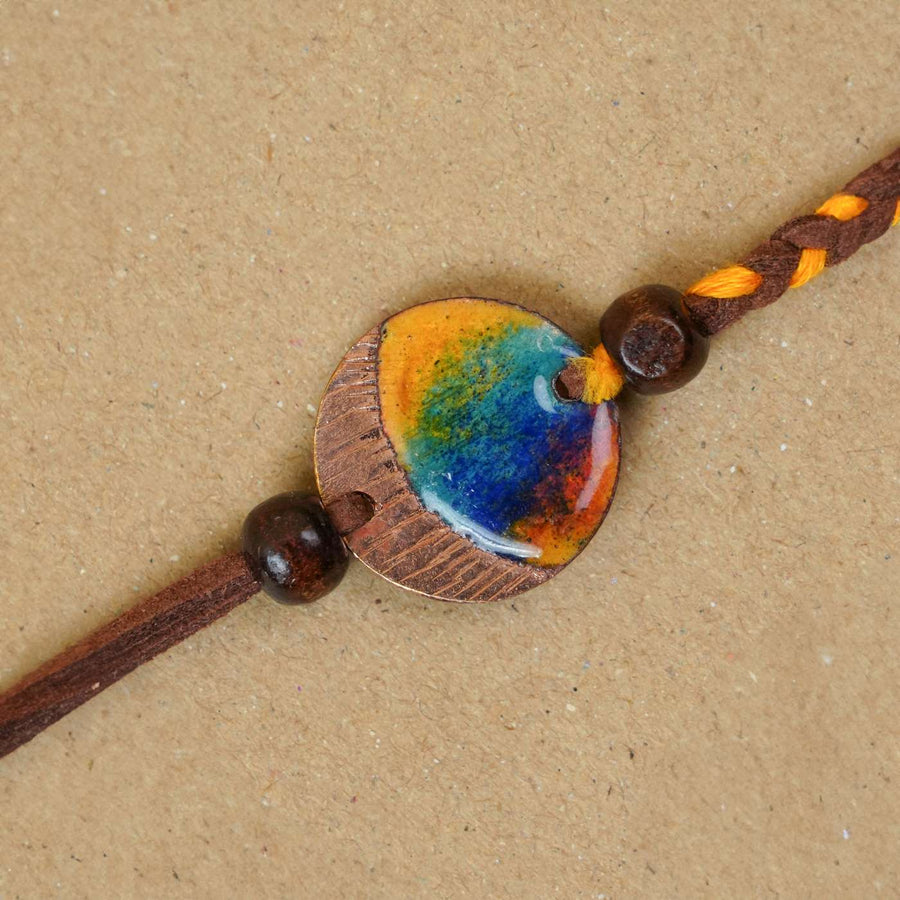 Handmade Indraa Textured Multicolour Copper Enamel Rakhi With Chocolates And Roli Chawal - Close-up of centerpiece detail