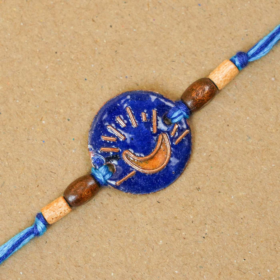 Handmade Chanda Blue Copper Enamel Rakhi With Chocolates And Roli Chawal - Close-up of Moon Design Bracelet