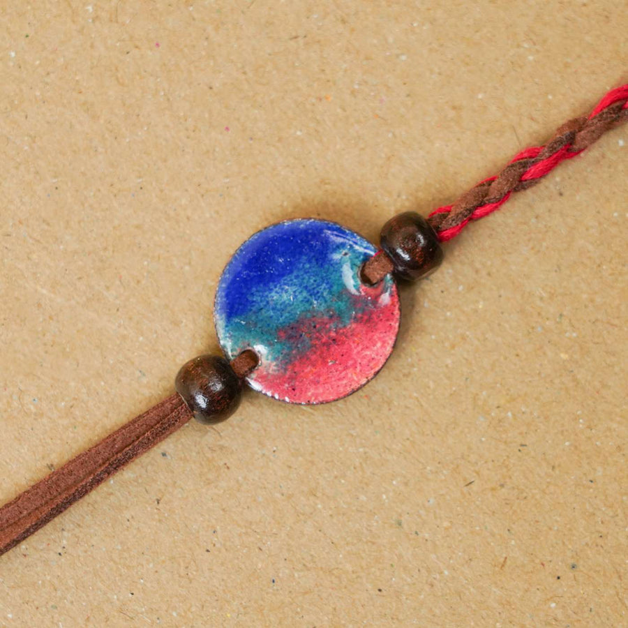 Handmade Rudra Red Copper Enamel Rakhi With Chocolates And Roli Chawal - Close-up of Bracelet Centerpiece