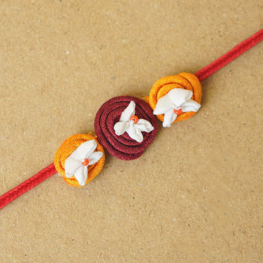 Handmade Roli Upcycled Fabric Rakhi With Roli Chawal - Close-up of textile bracelet detail