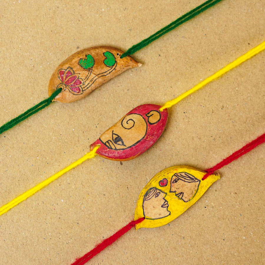 Handmade Plantable Ropan Seed Rakhi With Roli Chawal Set Of 3 - Close-up of three rakhis