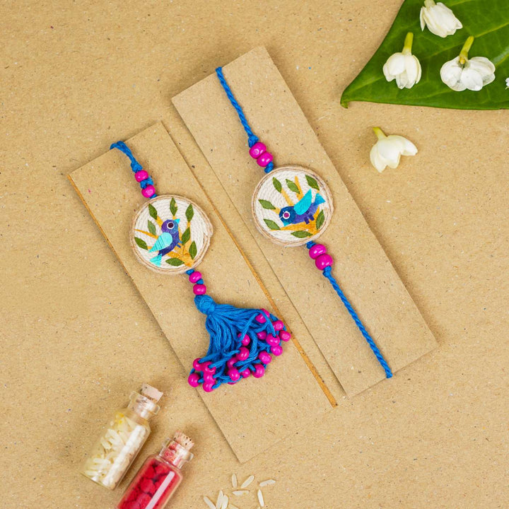 Handmade Pressed Flower Art Bluebird Jute Bhaiya Bhabhi Rakhi With Roli Chawal Set Of 2 - Two rakhis displayed together