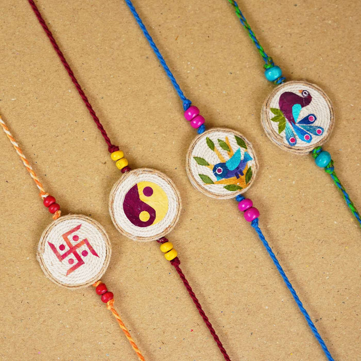 Handmade Pressed Flower Art Swastika Jute Rakhi With Roli Chawal - Group display of four bracelets